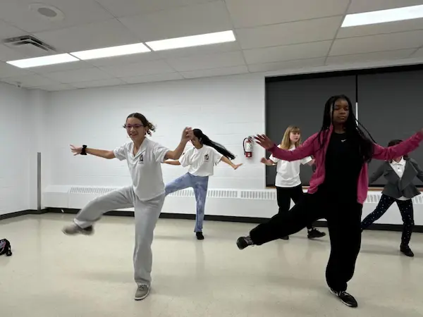 Students participating in a group dance class